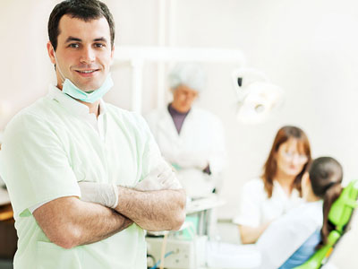Dental: A dentist supervising a medical procedure