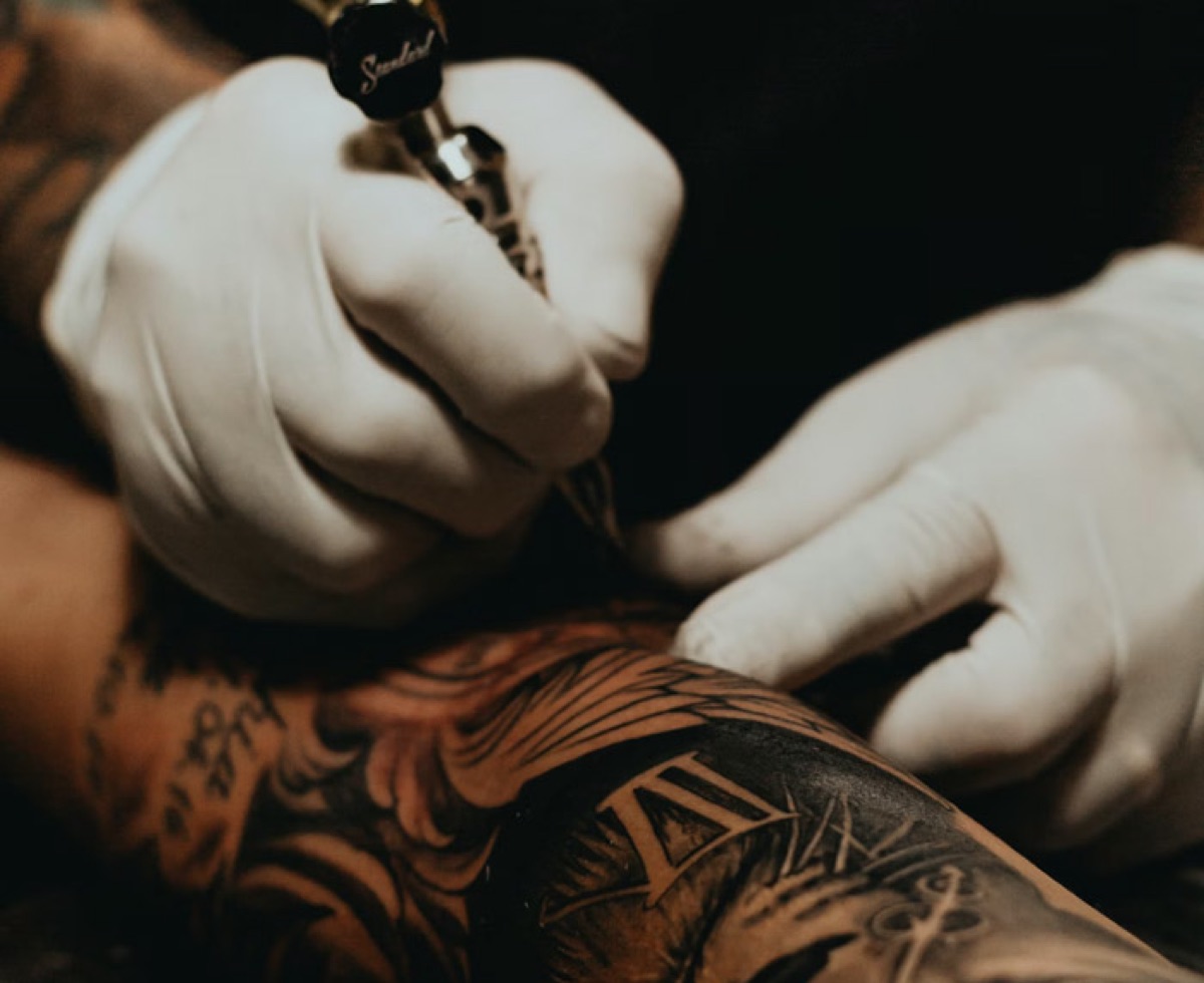 someone getting a tattoo on their arm